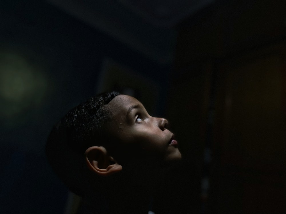 a boy looking up at a light