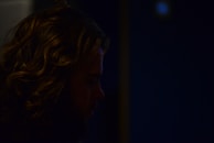 A tasteful shot of Tiara Parisi’s profile framed by flowing dark hair and delicate shadows.