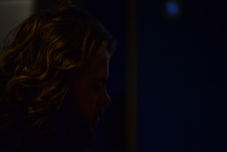 A tasteful shot of Tiara Parisi’s profile framed by flowing dark hair and delicate shadows.