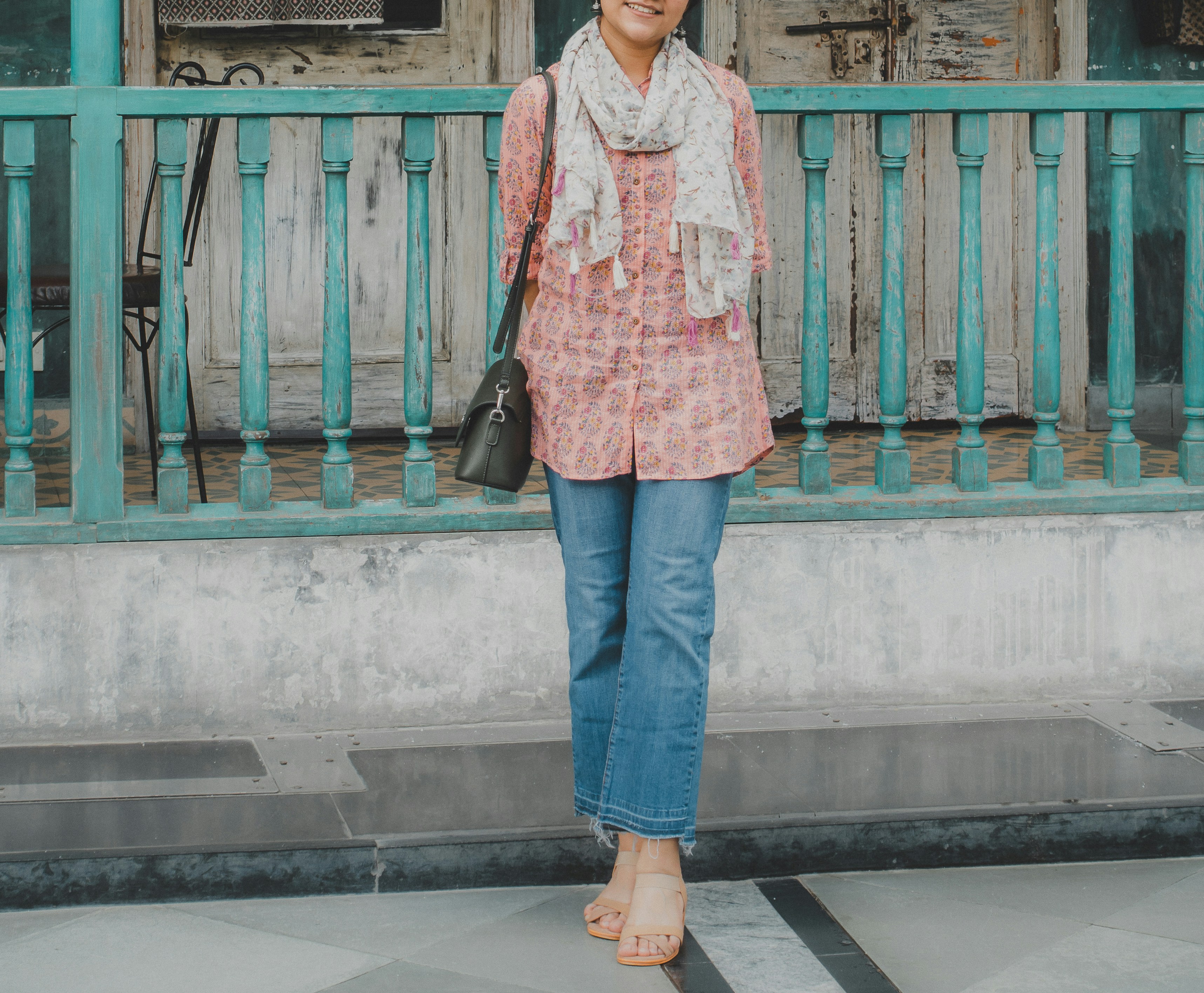 a woman standing on a sidewalk