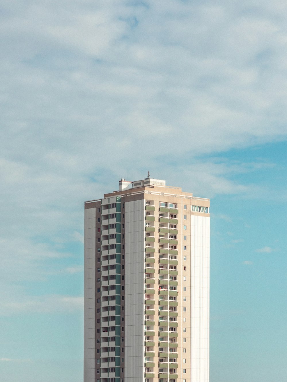 a tall building with a cloudy sky