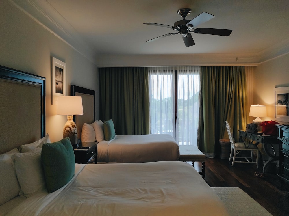 a bedroom with a large bed and a fan