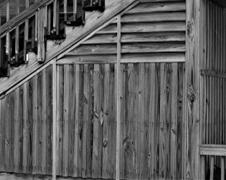 Rectangular black and white image of a handcrafted wooden staircase with sharp edges and clean lines.