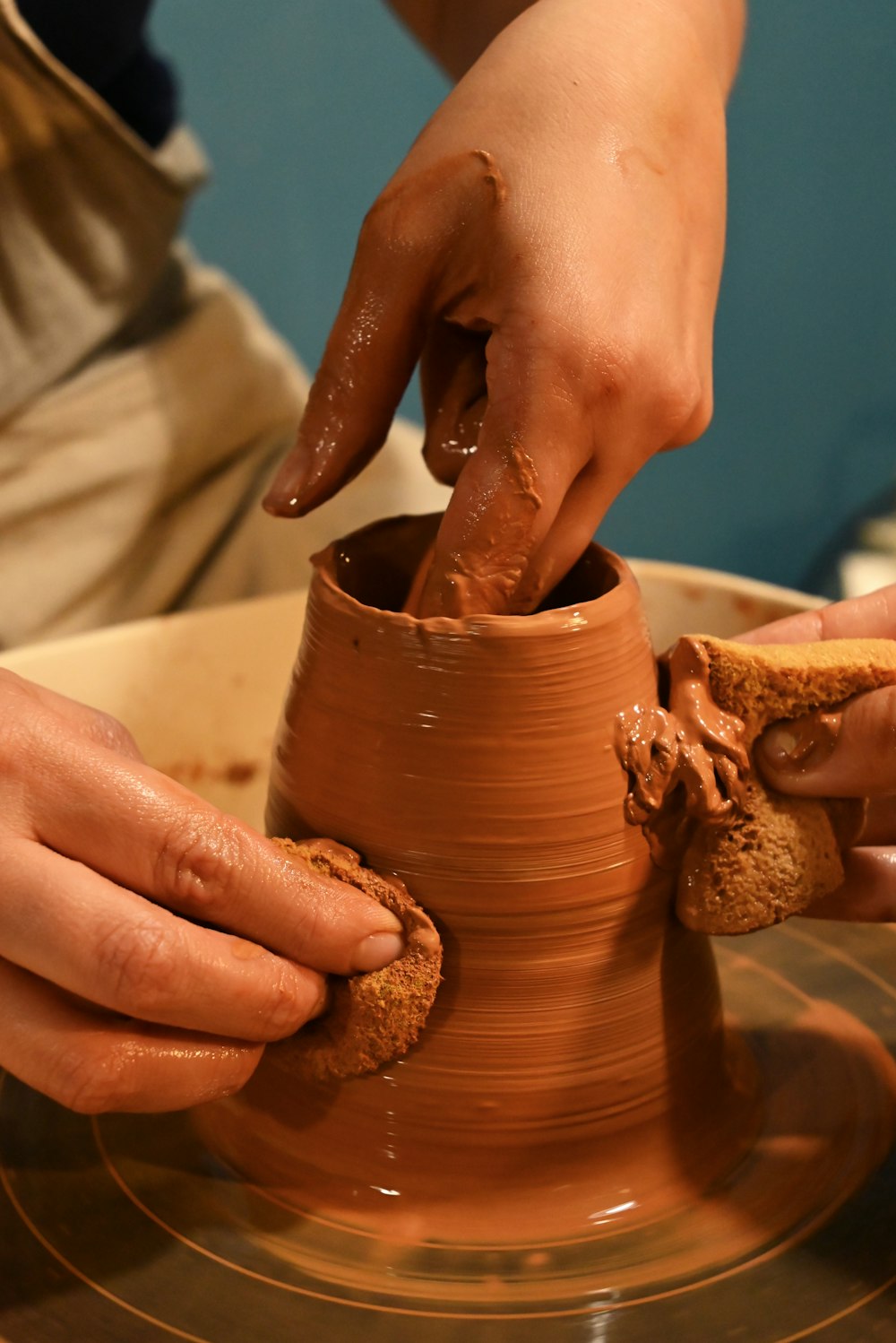a person holding a clay pot