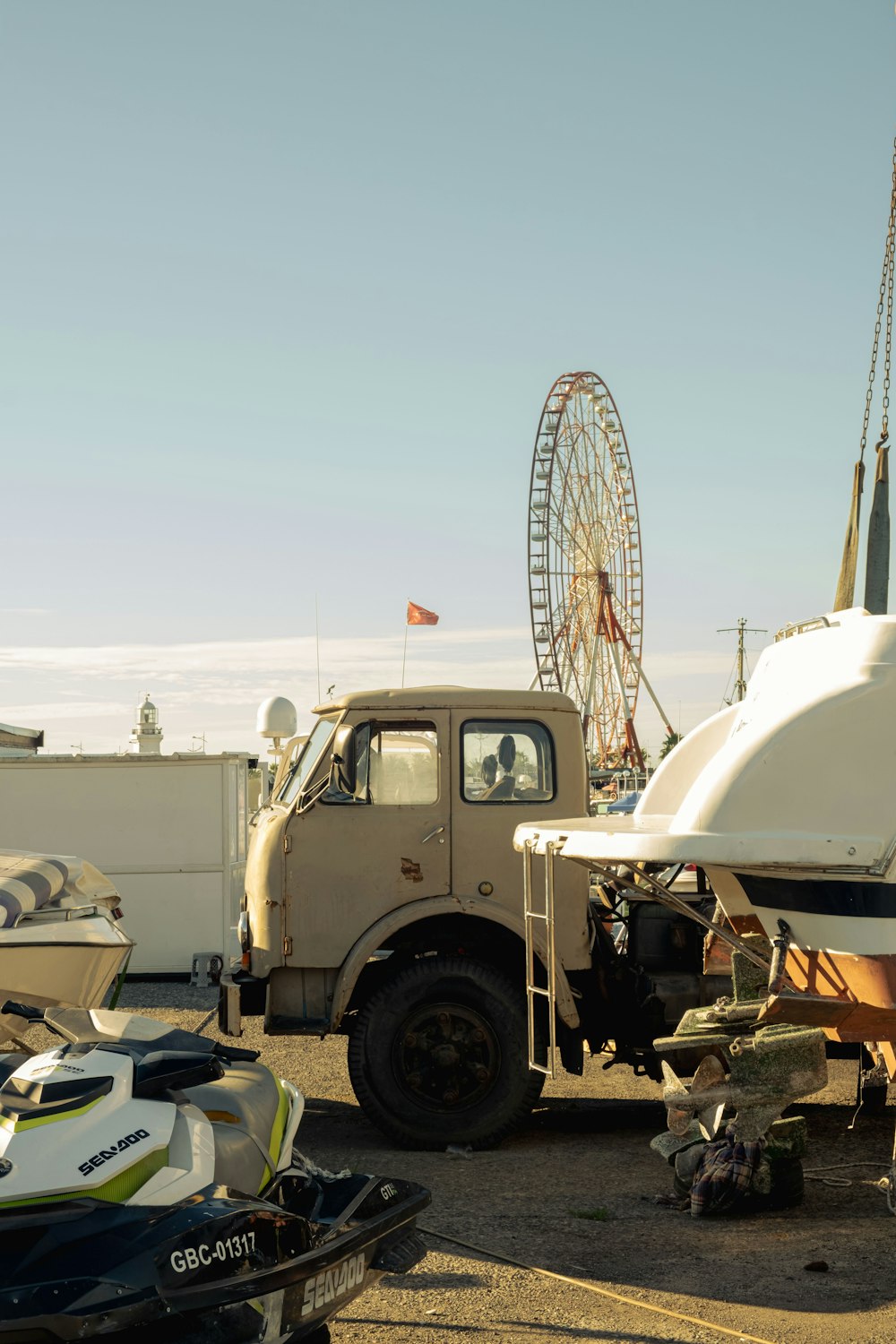 a truck parked next to a ferris wheel