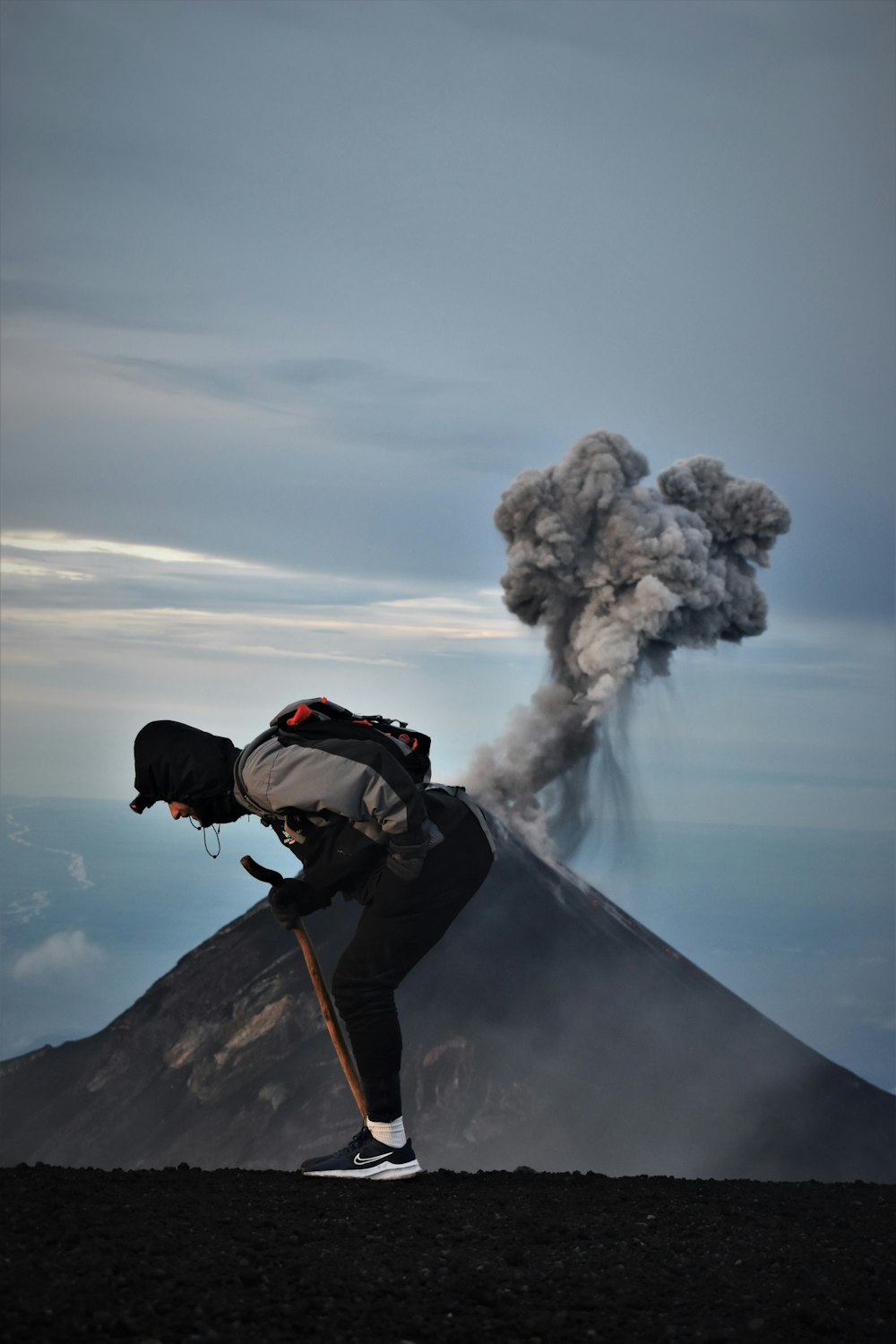 a person with a stick on a mountain