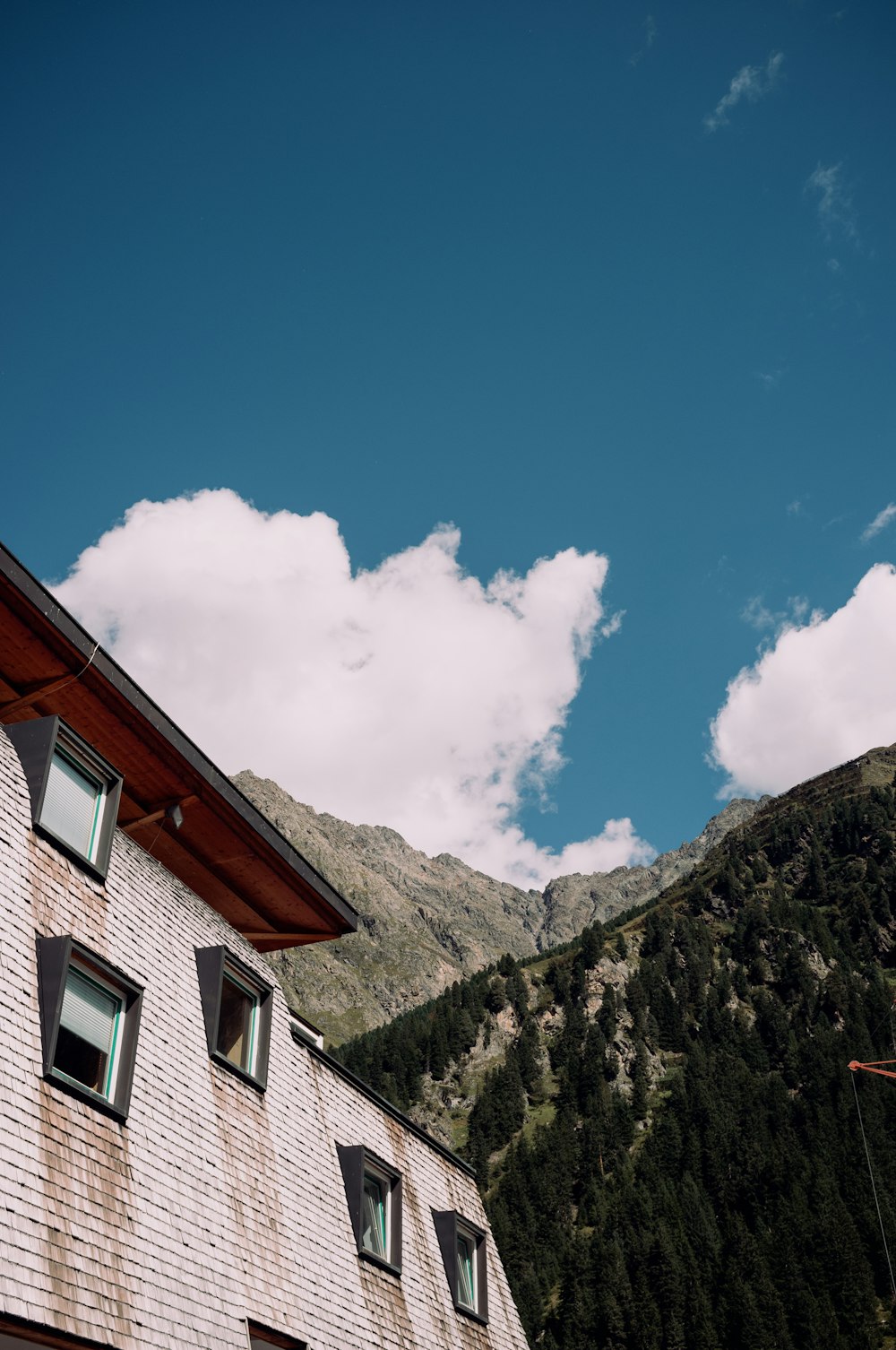 a building with a hill in the background