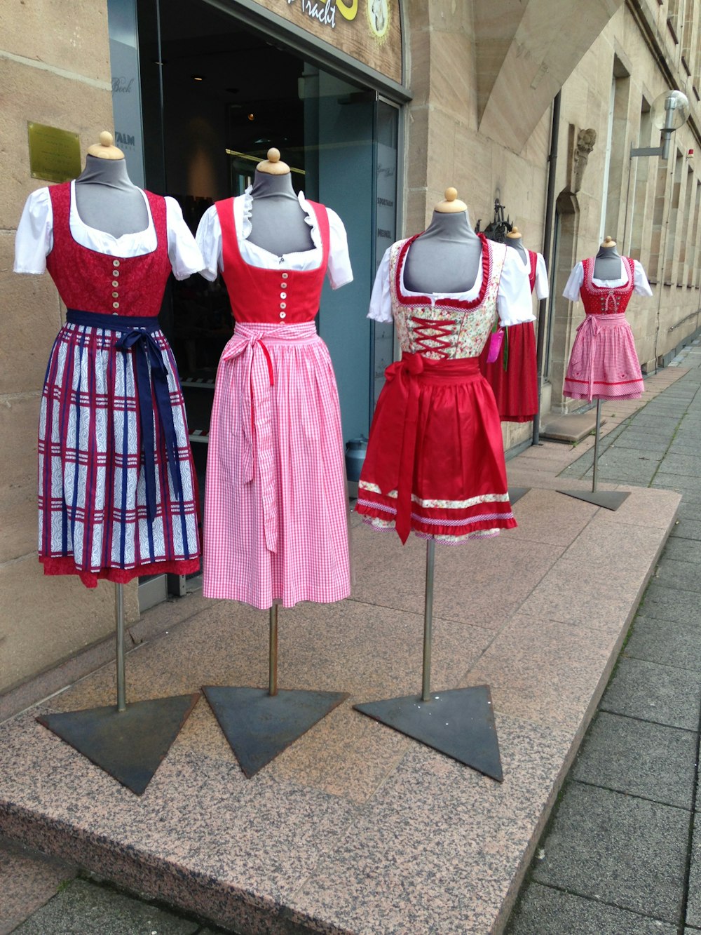 a group of dresses on display