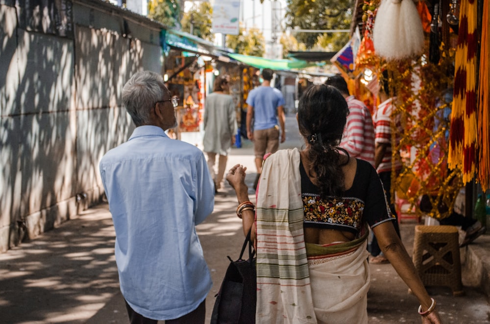 a man and woman walking down a street