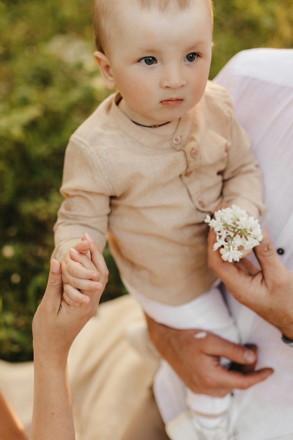 a baby holding a flower