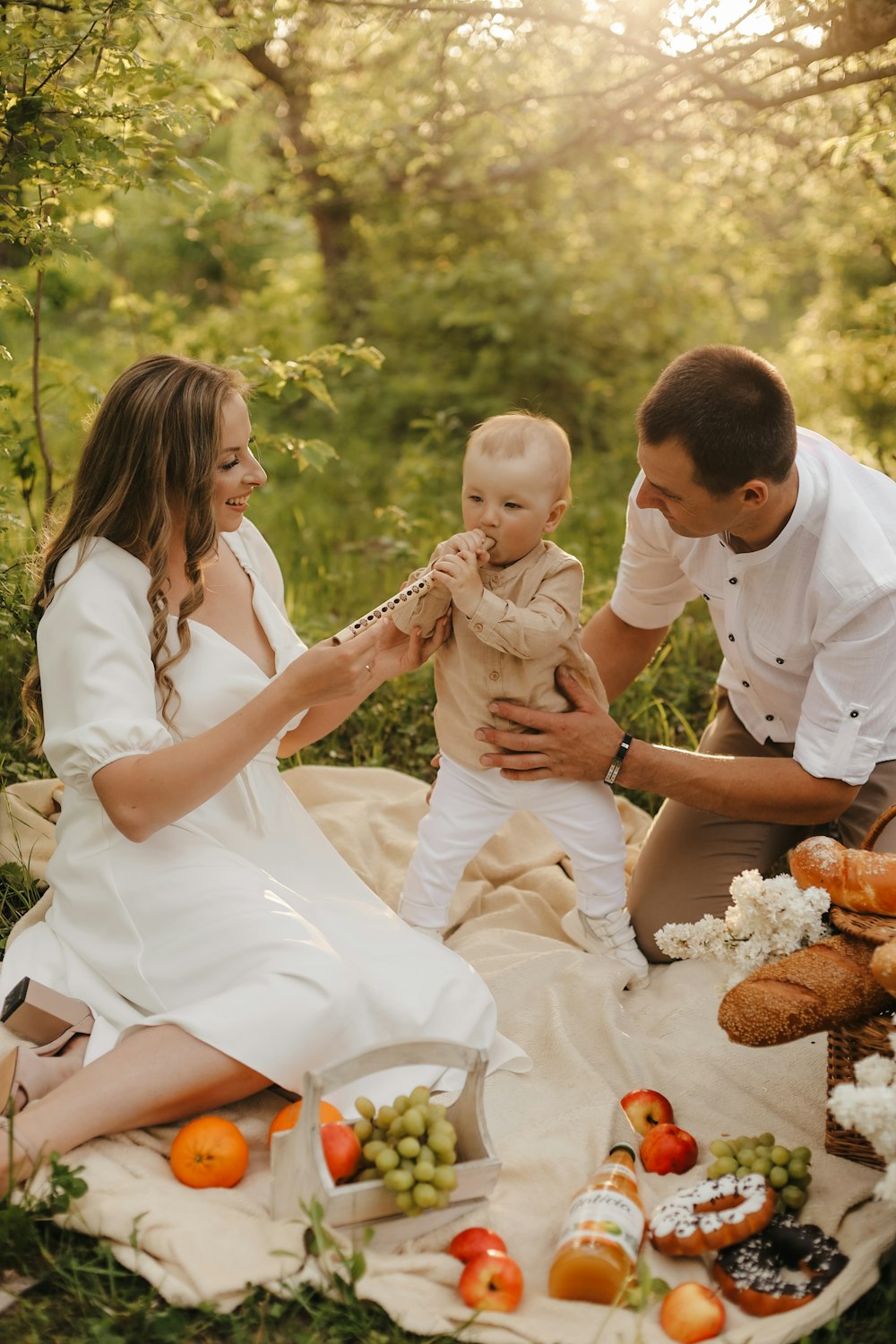 a man and woman holding a baby