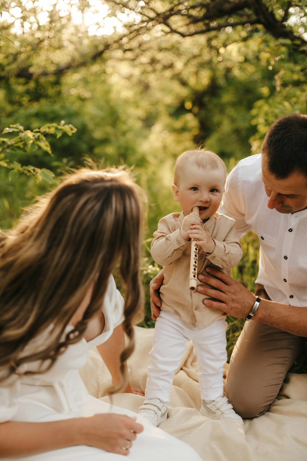 a man and woman holding a baby