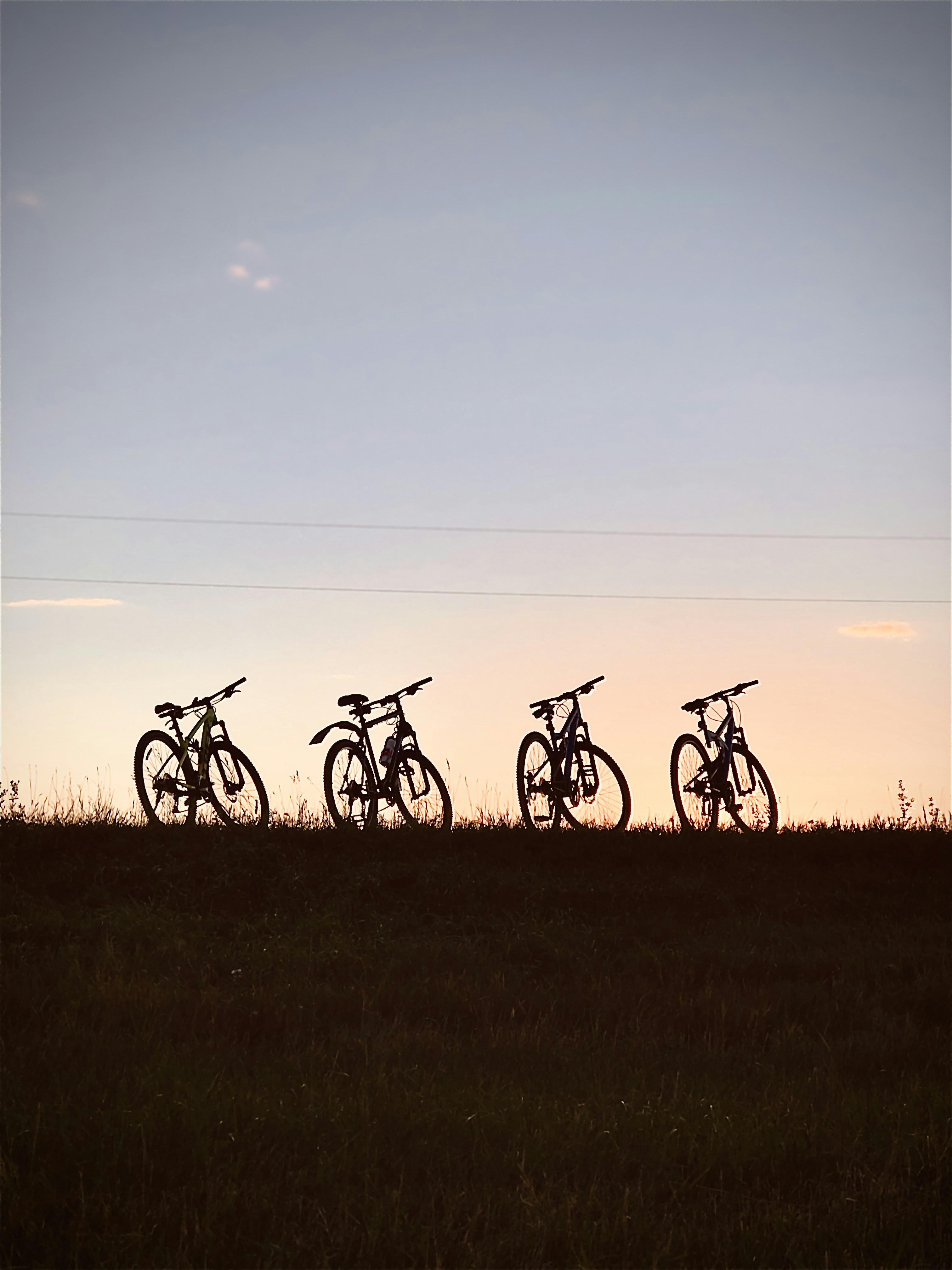 a group of bikes parked on a grassy hill
