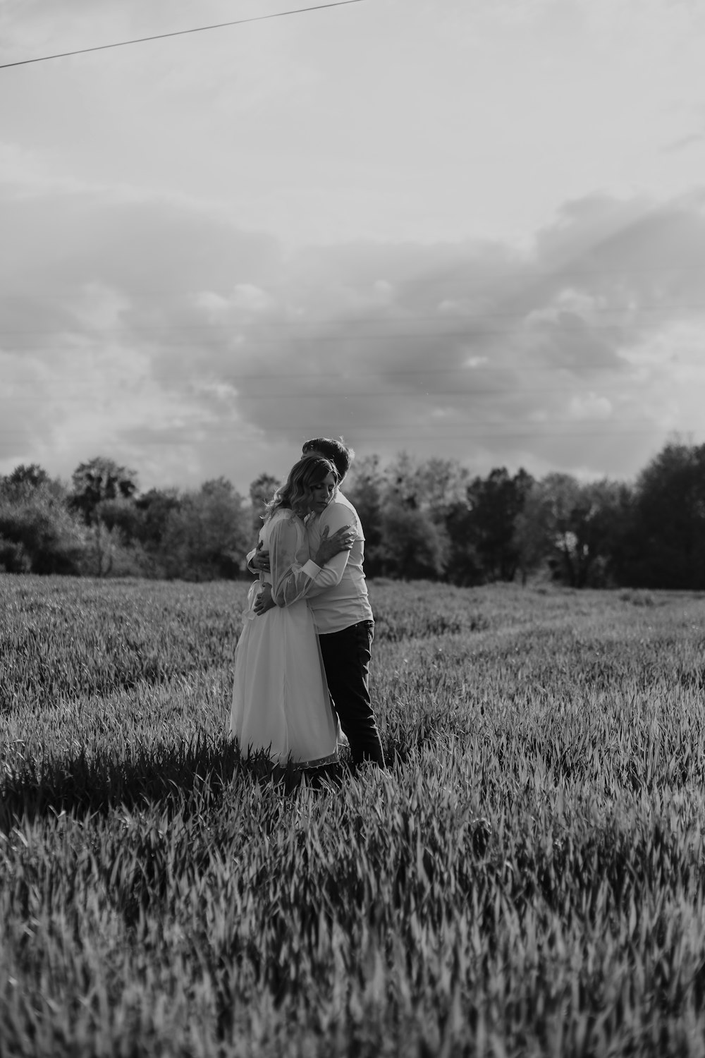 a man and woman kissing in a field