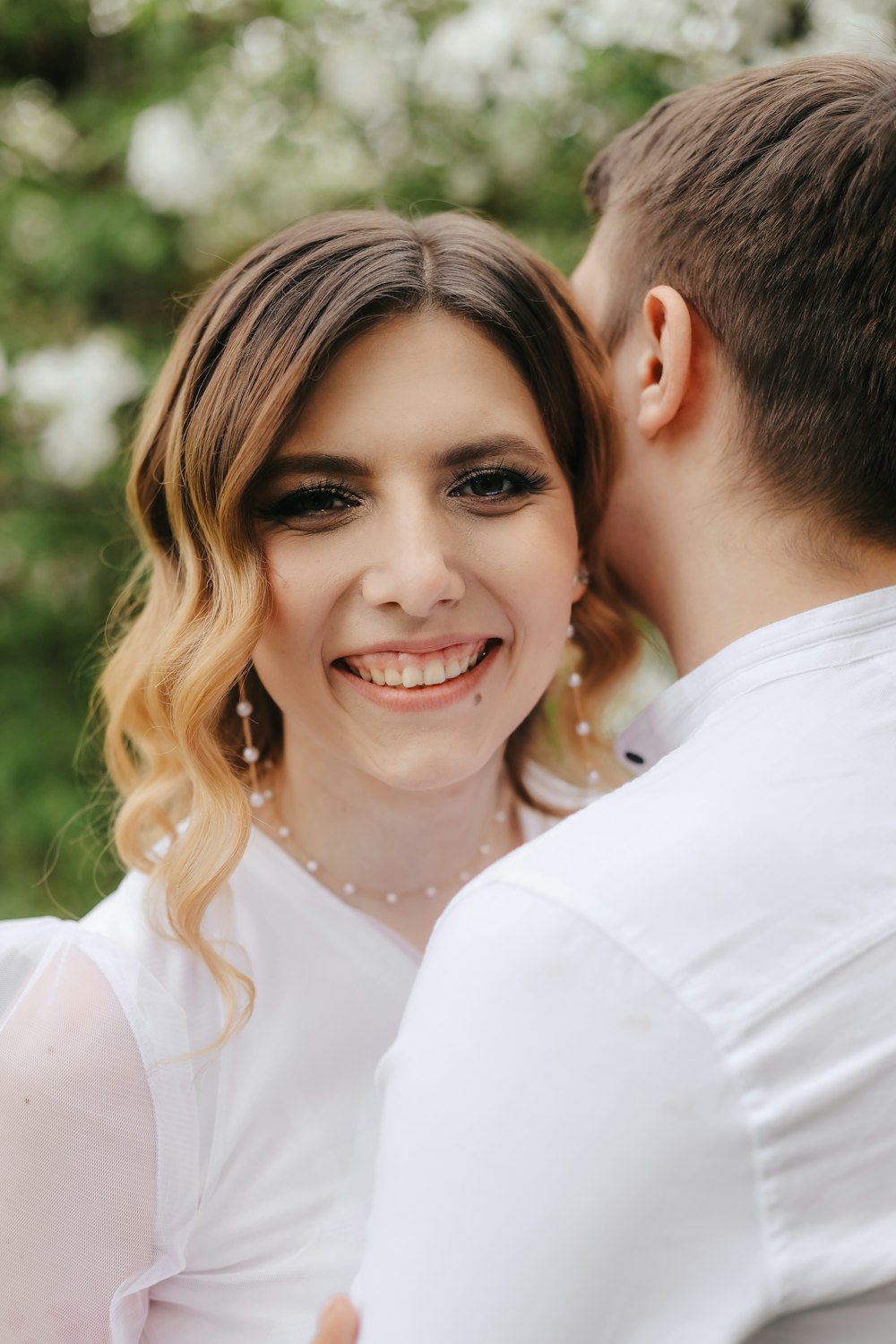 a man kissing a woman on the cheek