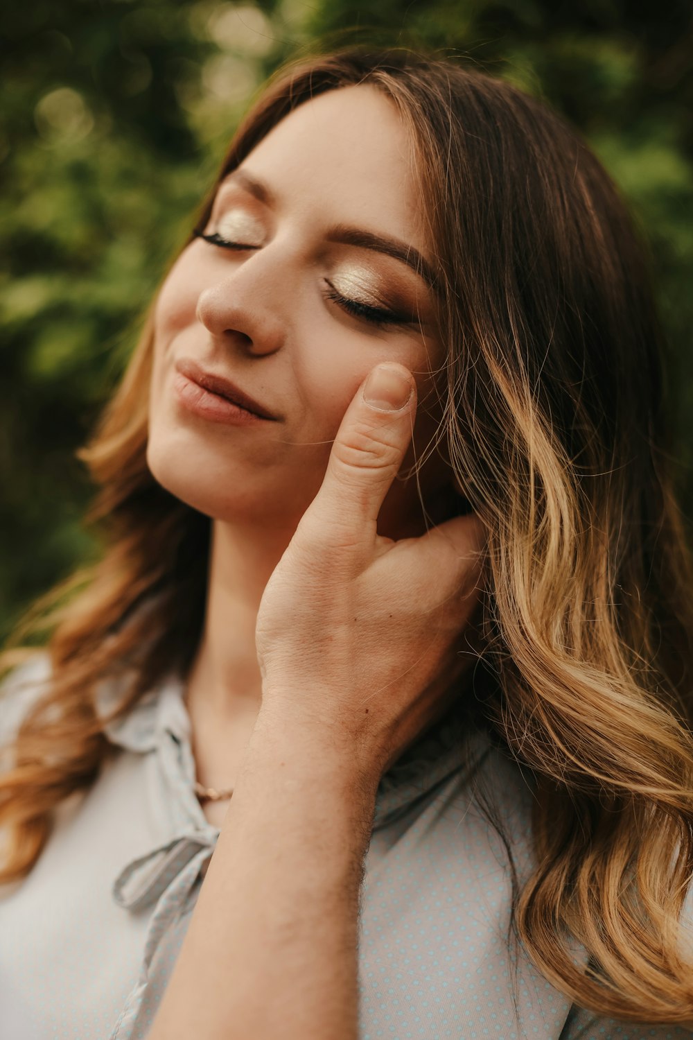 a woman with her hand on her face