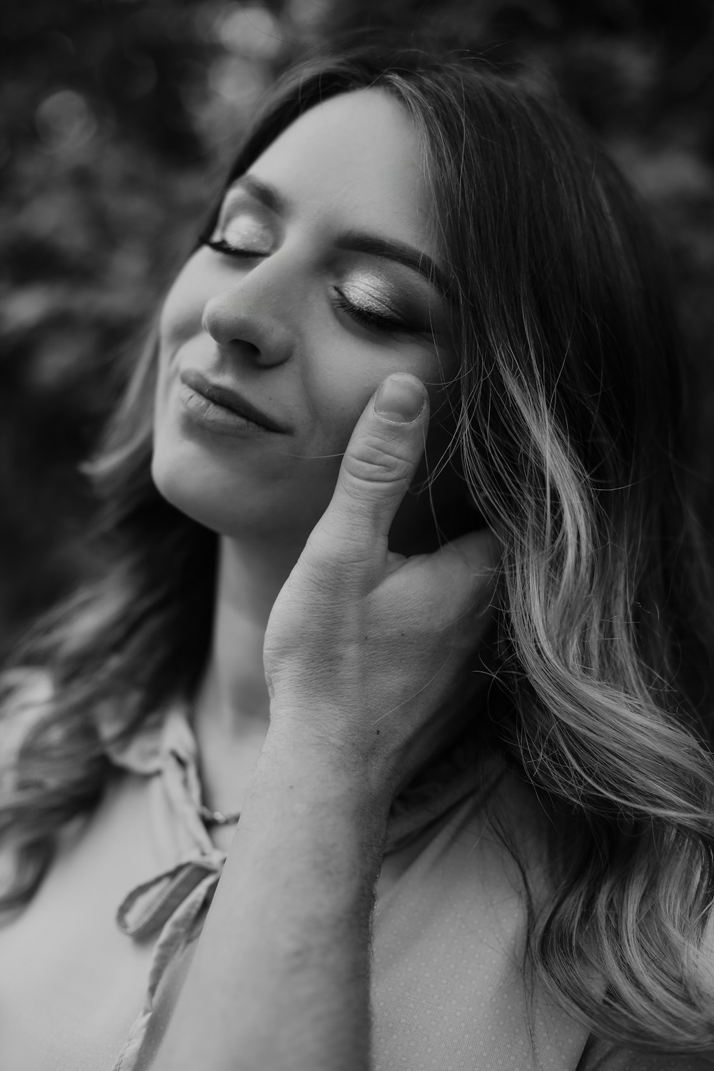 a woman with her hand on her face