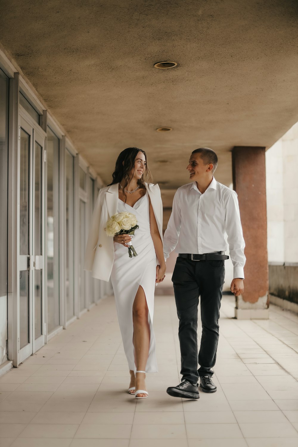 a man and woman walking down a hallway