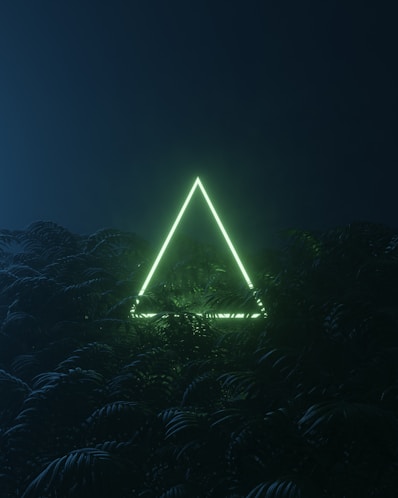 a pyramid with lights at night