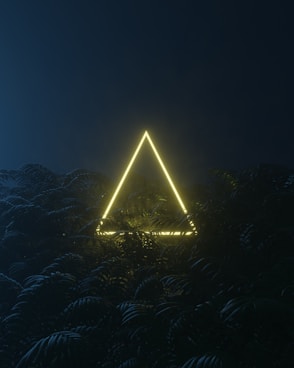 a large pyramid with lights at night