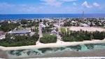 a beach with a pool and buildings