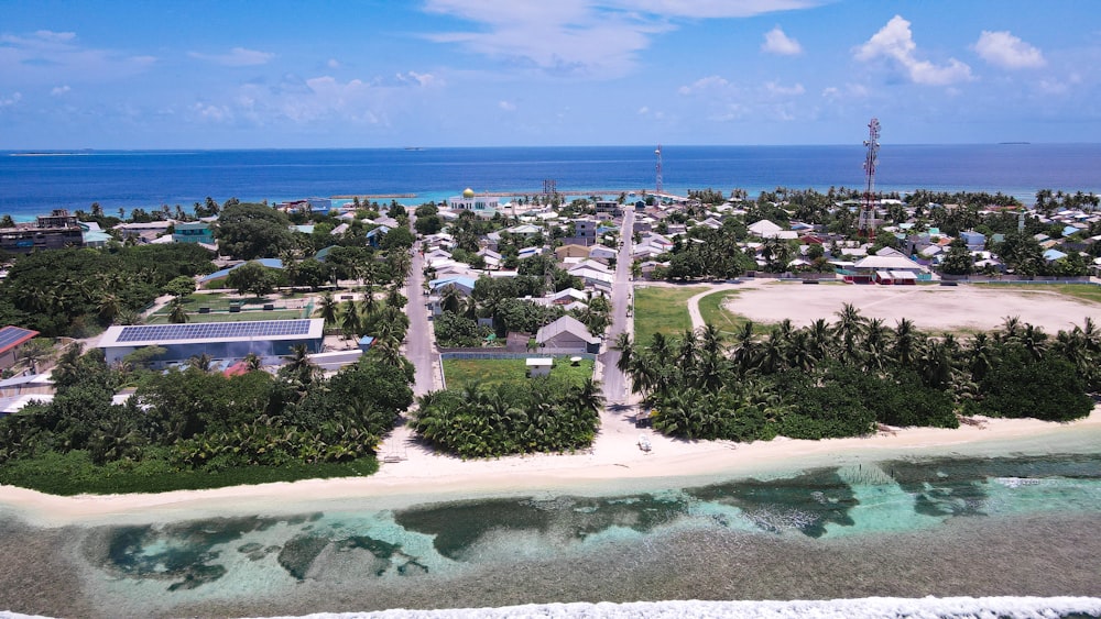 a beach with a pool and buildings