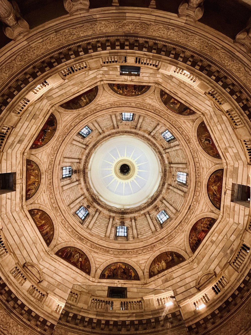 a large domed ceiling with a circular ceiling and a circular window