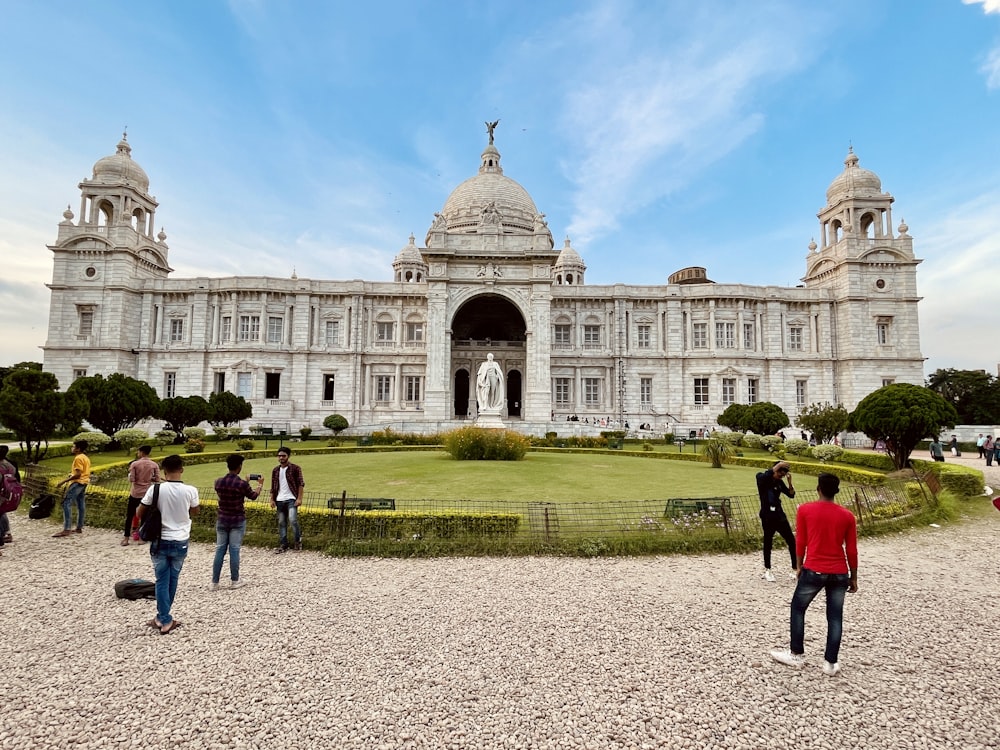 a large white building with a dome with Victoria Memorial Hall in the background