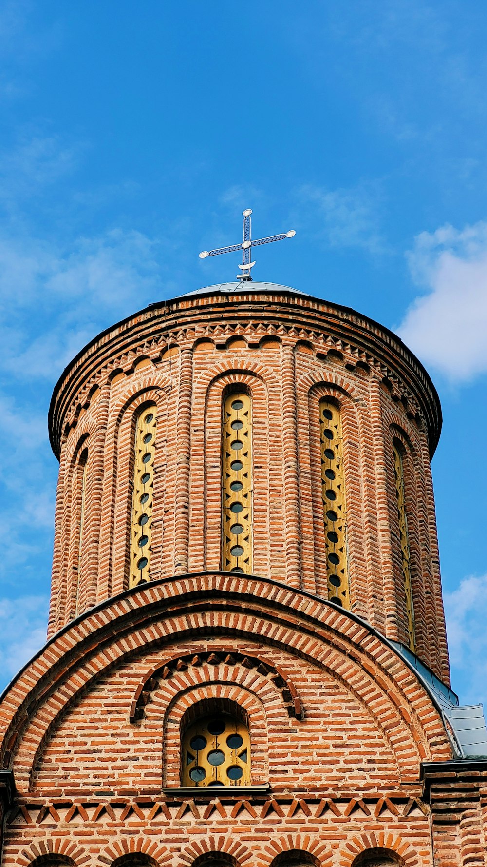 a large brick building with a cross on top