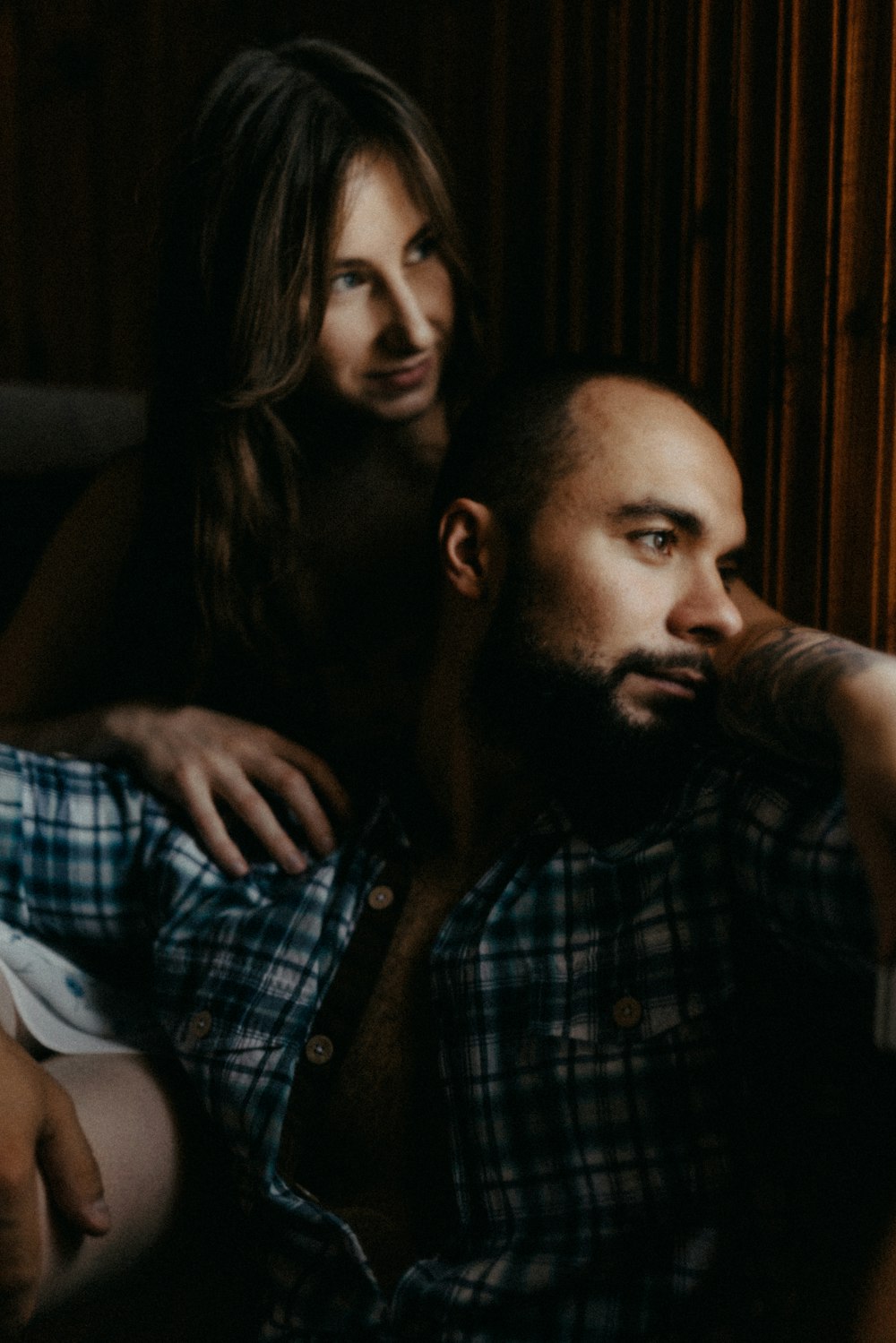 a woman leaning on a man's shoulder