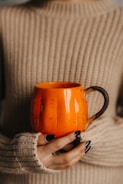a hand holding a tea cup