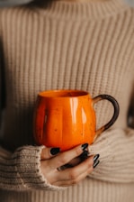 a hand holding a tea cup
