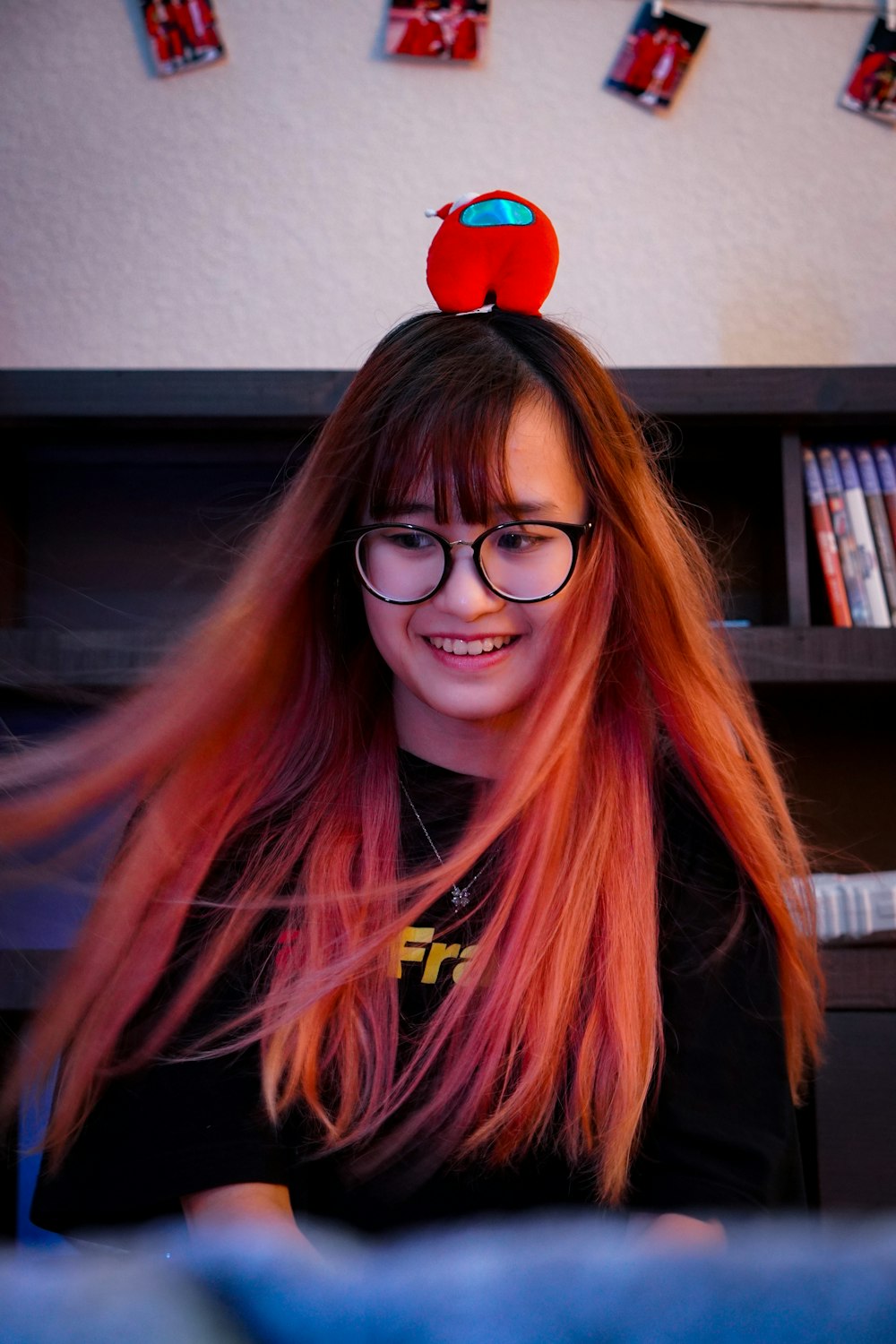 a person with long hair and glasses