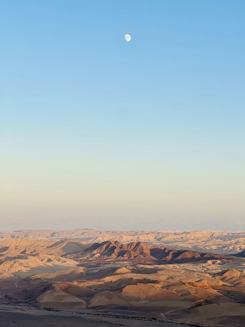 a desert landscape with a moon