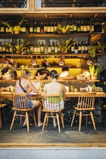 a group of people sitting at a bar