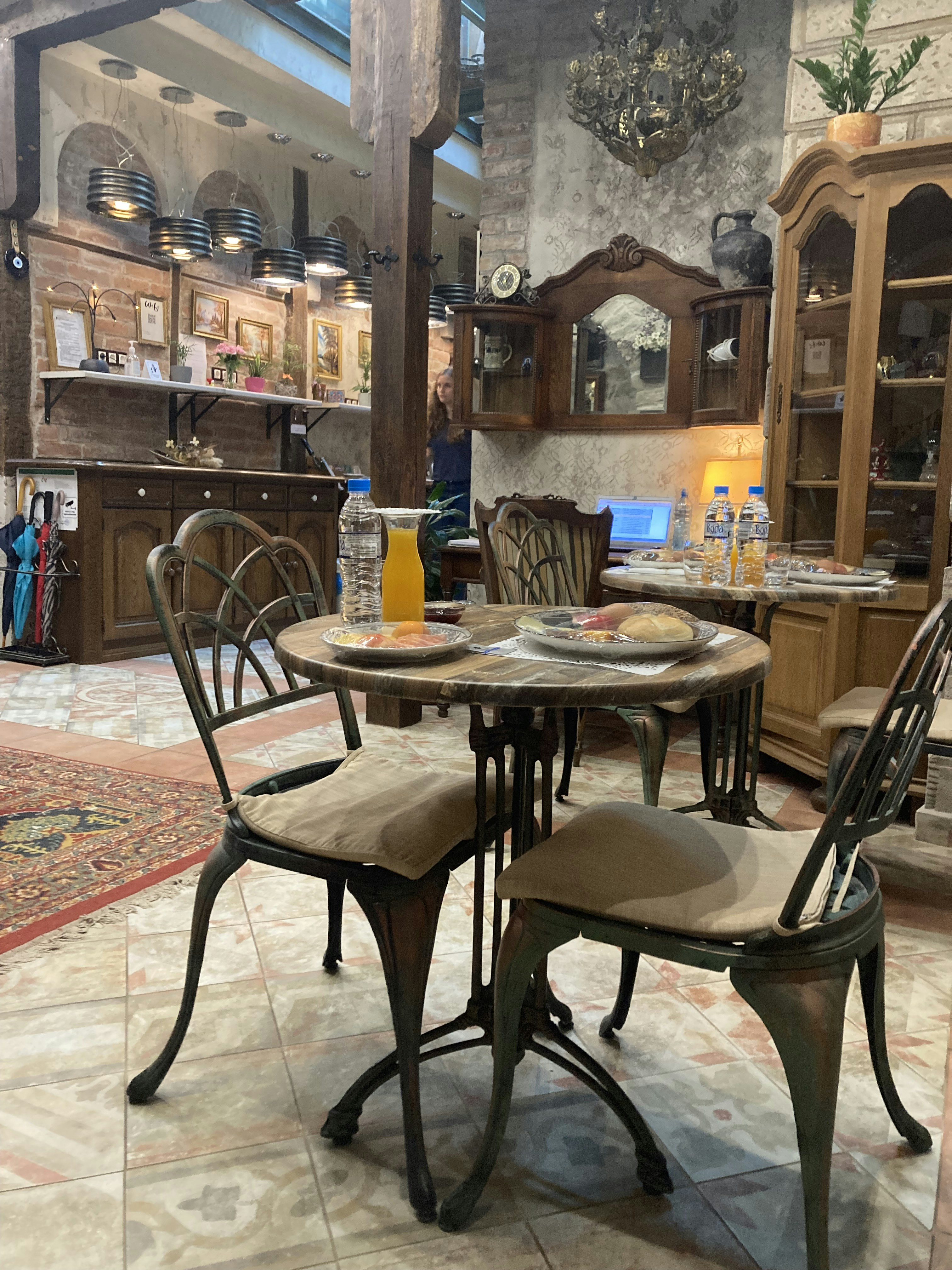 Cozy rustic dining area with wooden tables and warm lighting inside the biesy guesthouse.