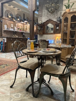 A cozy rustic restaurant table set with traditional dishes from the 65 region.