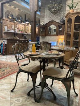 A cozy, candlelit dining room inside one of the oldest European restaurants, with vintage wooden tables and historic decor.