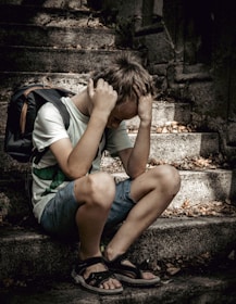 a man sitting on a stone ledge