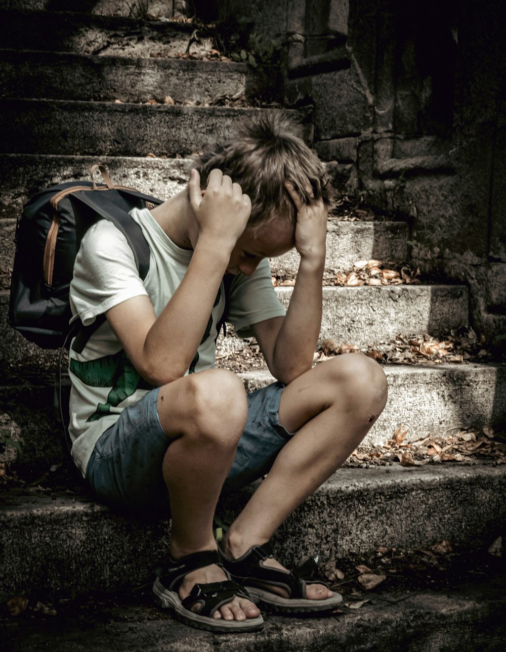 a man sitting on a stone ledge