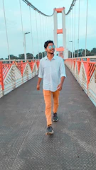 A person confidently crossing a bridge, representing moving forward decisively.