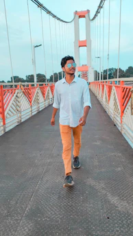 A person confidently crossing a bridge, representing moving forward decisively.