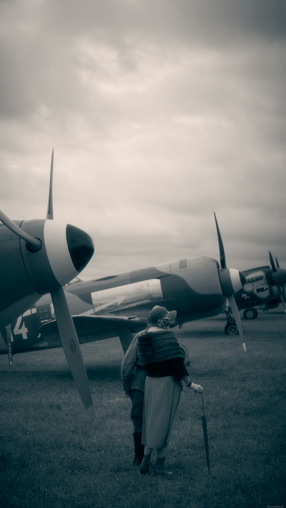 a couple of people standing next to a plane