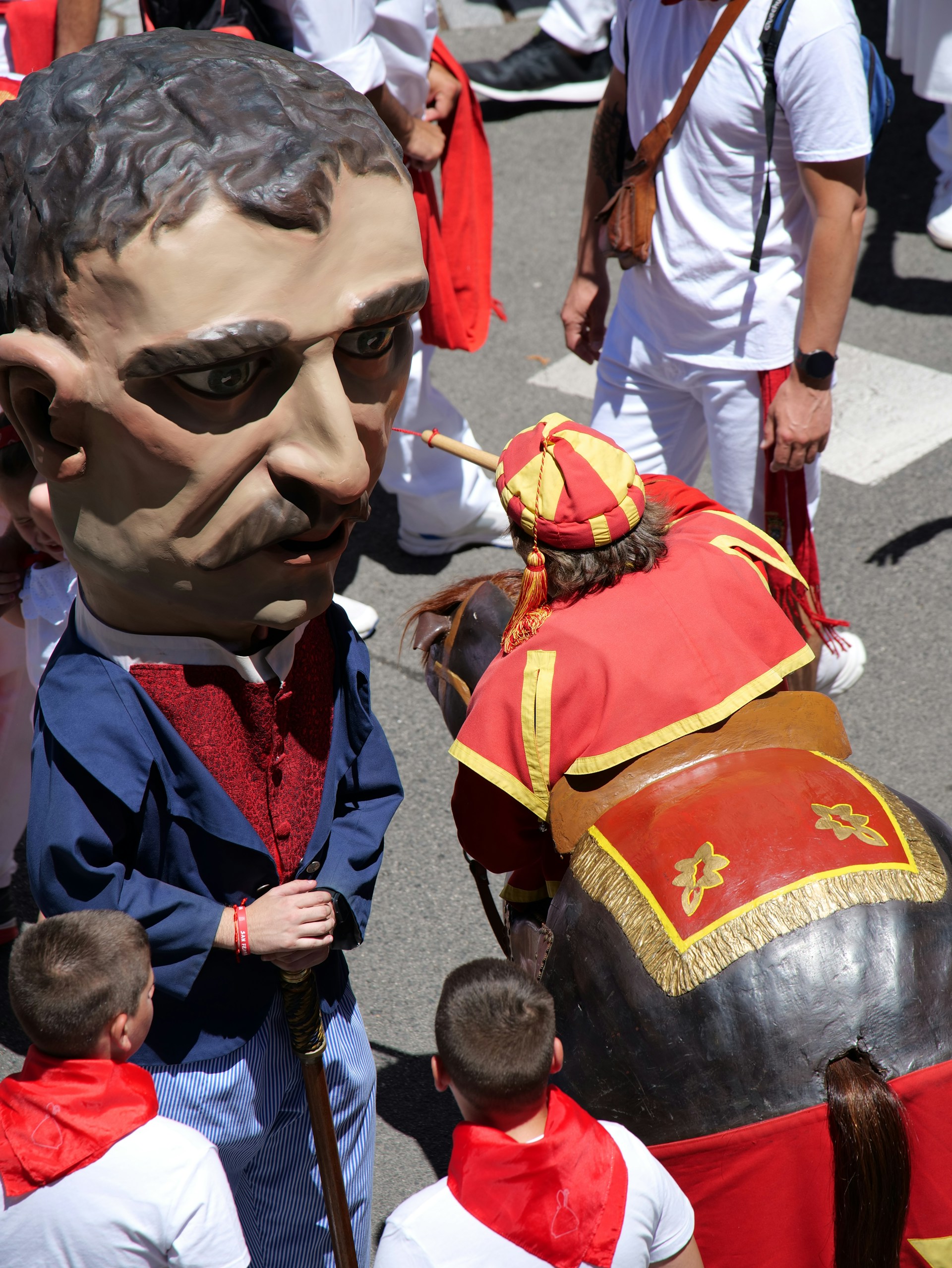 A vibrant scene of the San Fermín festival with locals and visitors dressed in traditional red and white, capturing the energy of the running of the bulls.