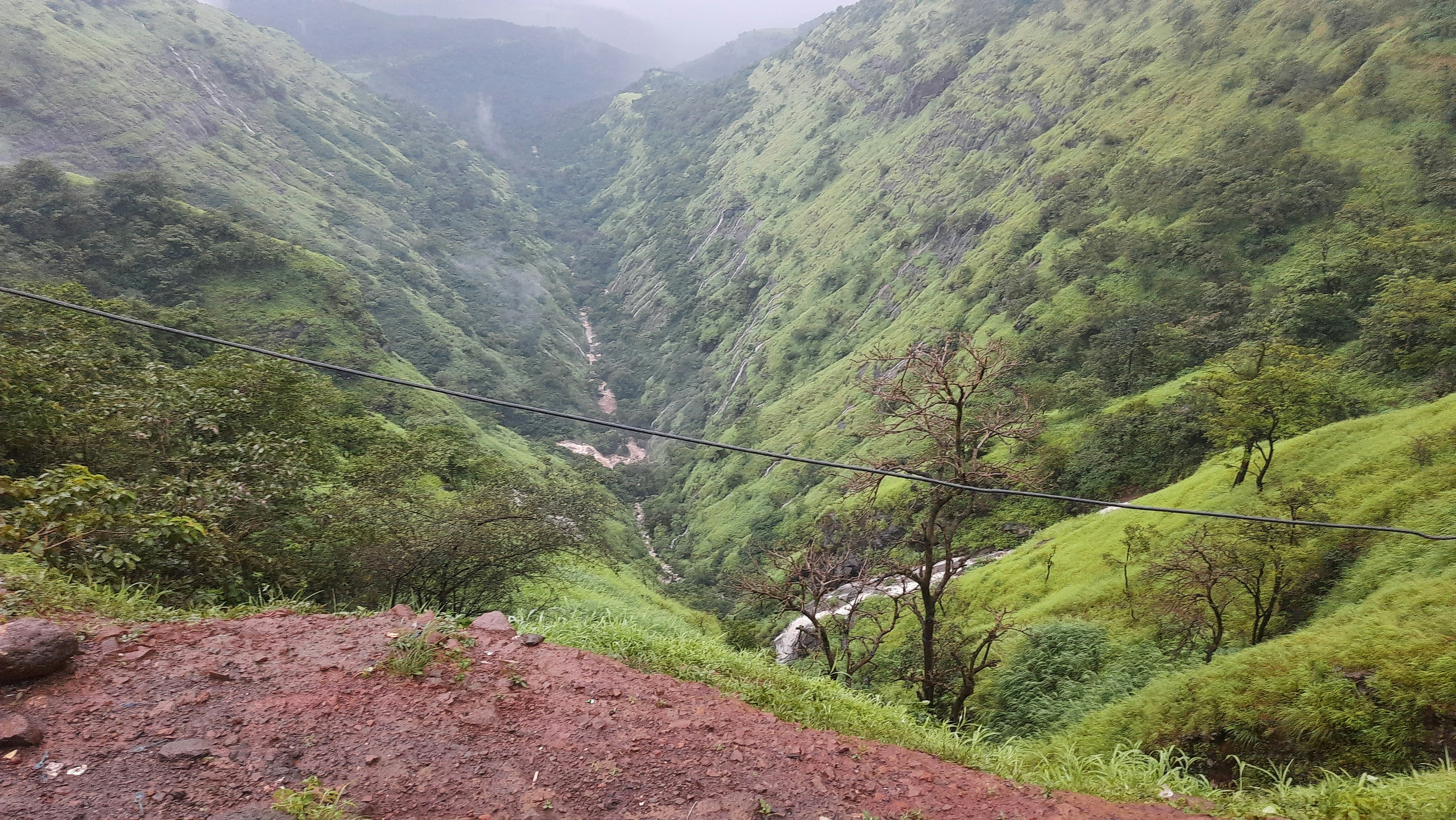 a dirt road in a valley