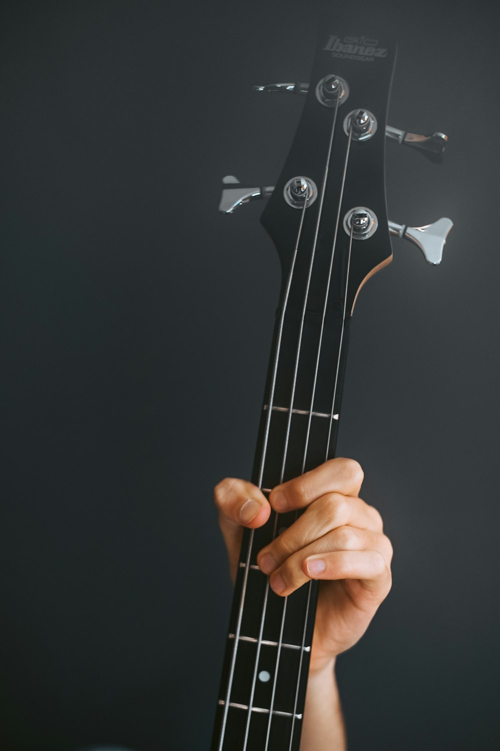 a hand holding a guitar