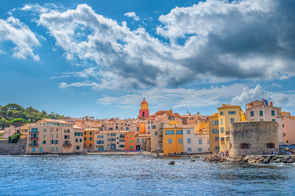 a group of buildings next to a body of water