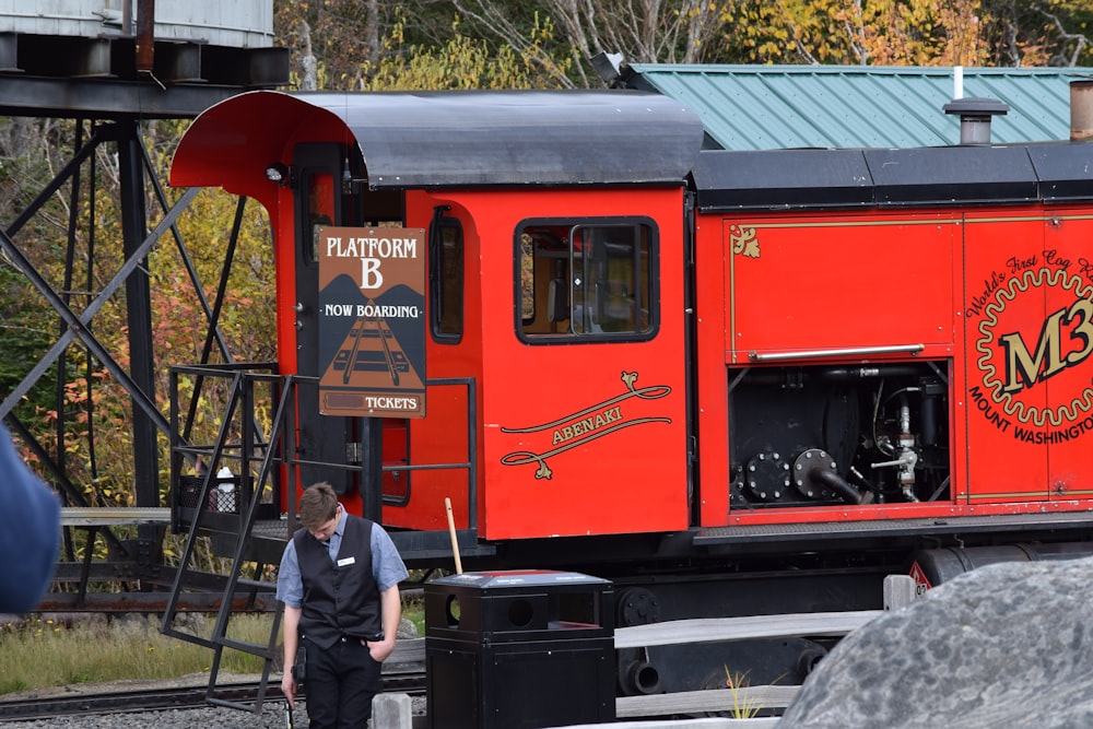 a person standing next to a train