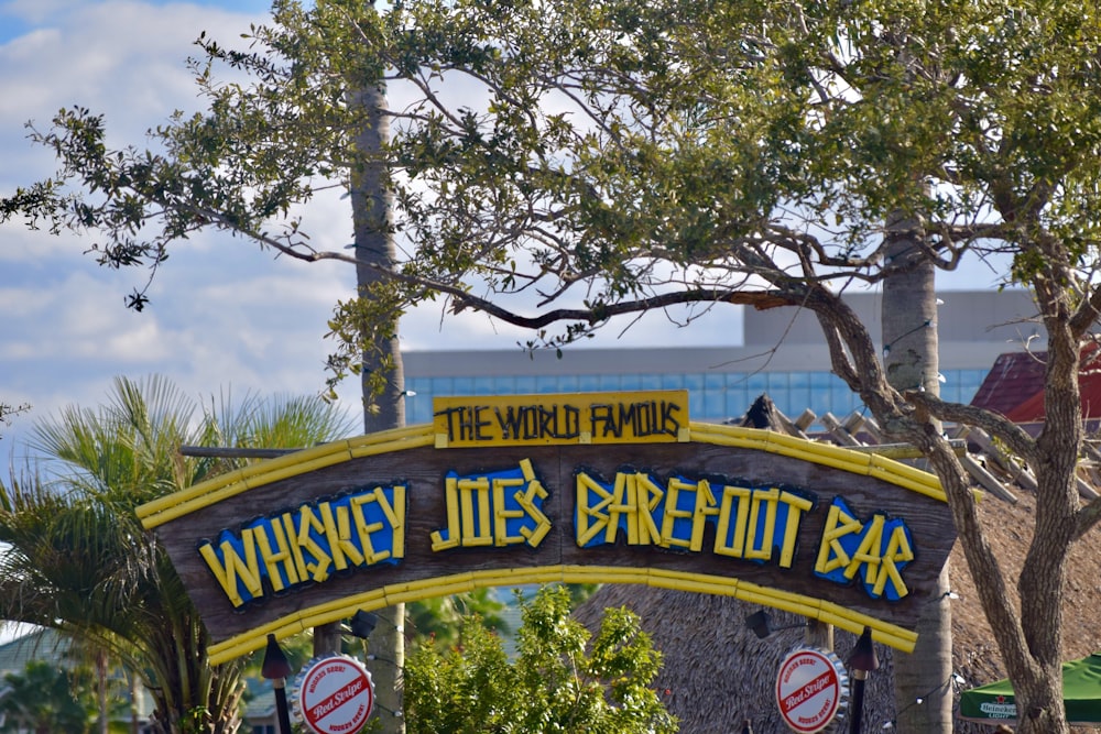 a sign with trees in the background