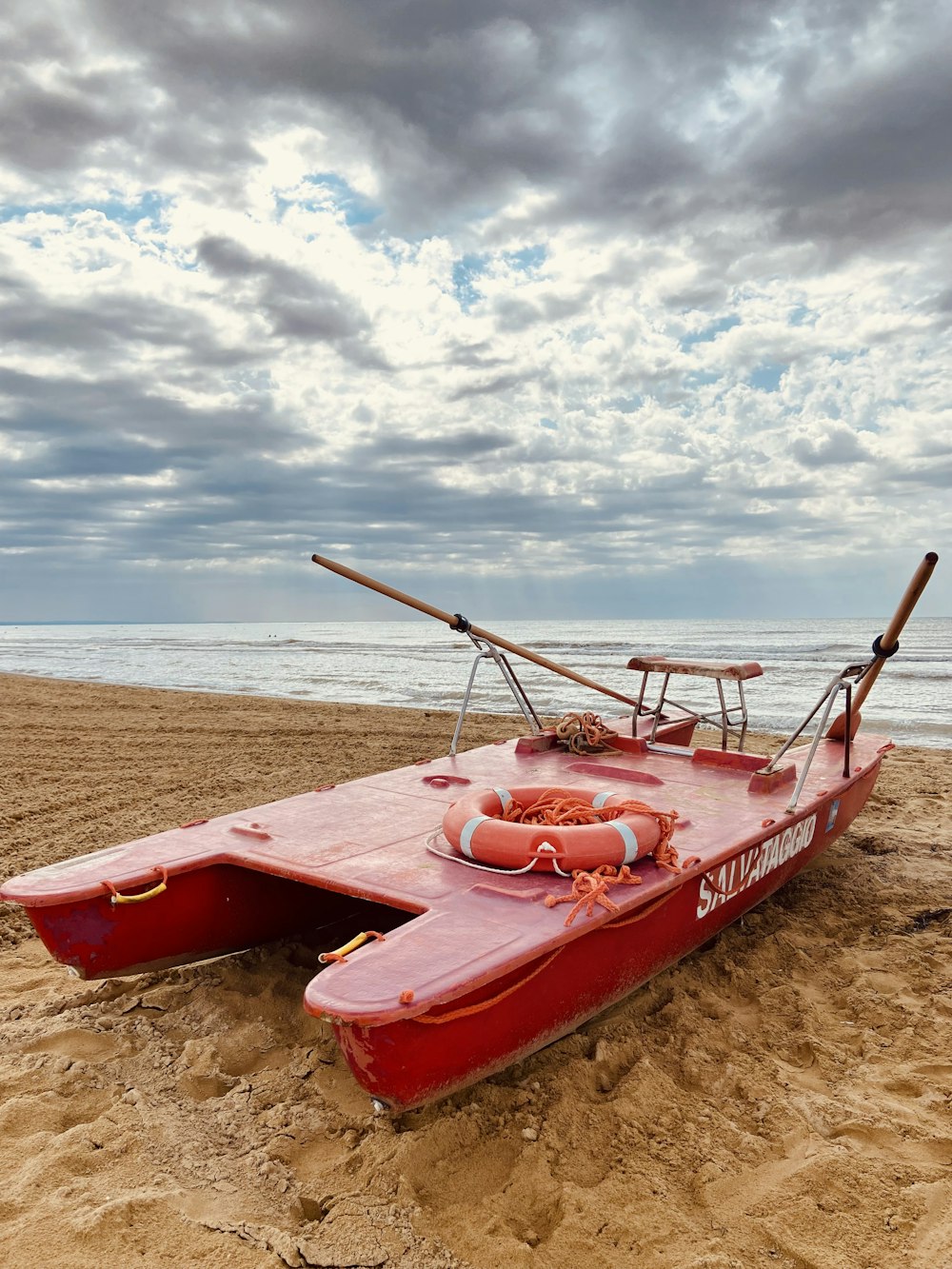 a boat on the beach with Lake Retba in the background